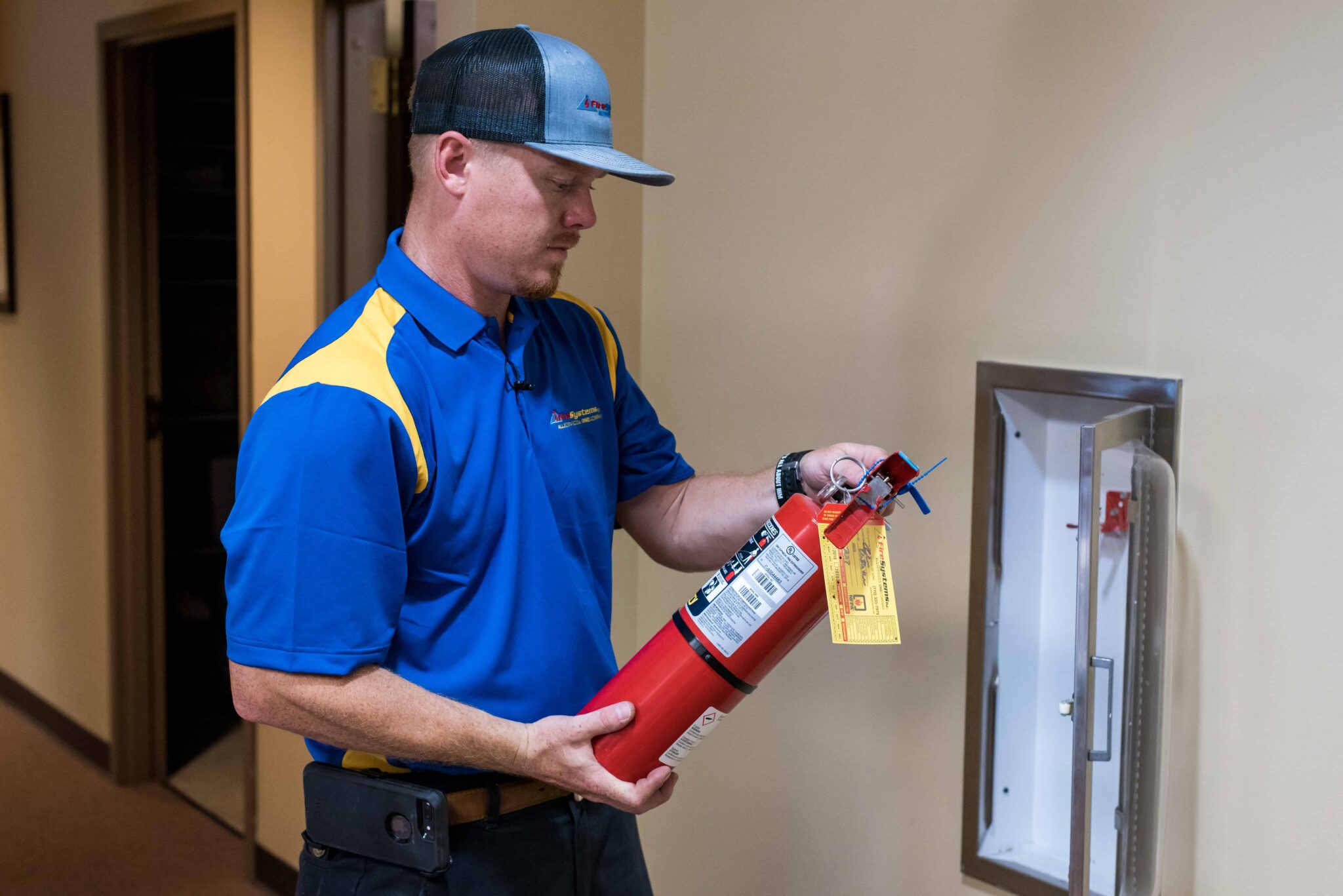Technician installing and integrating fire alarm systems into a building's safety network